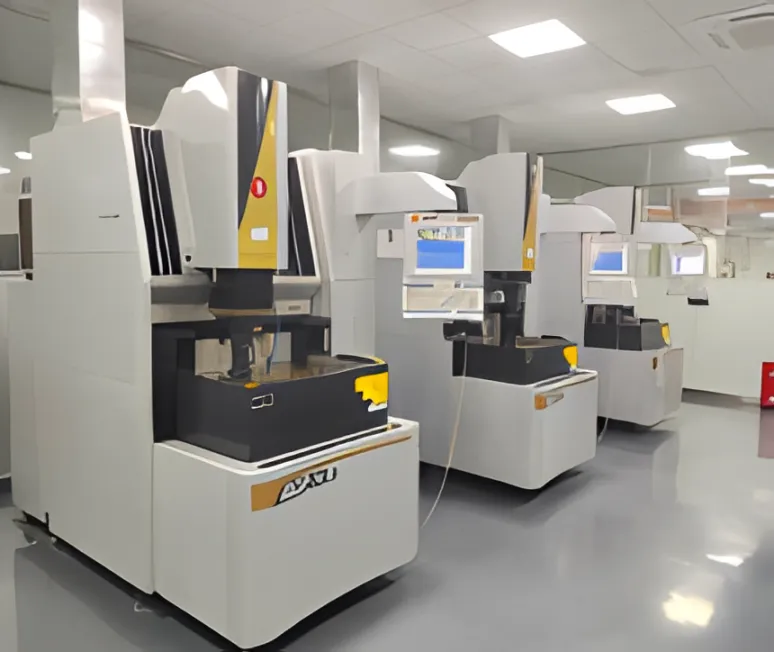 White inspection machines with measuring heads in a bright workshop.
